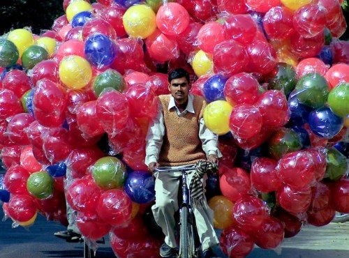 images_funny_man_riding_bicycle_with_balloons