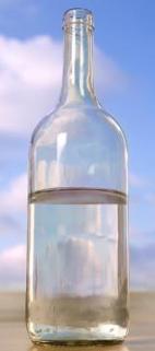 Transparent bottle of water against a cloudy sky
