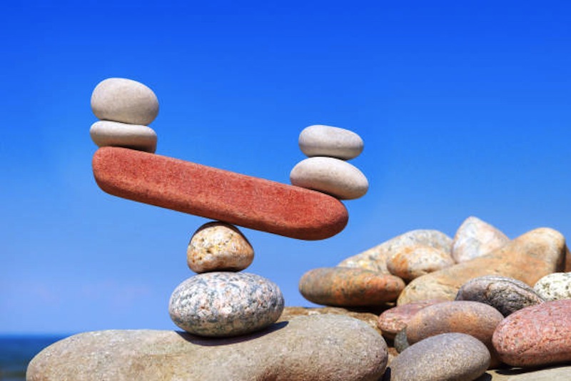 Symbolic scales from stones. The disturbed equilibrium. Imbalance concept